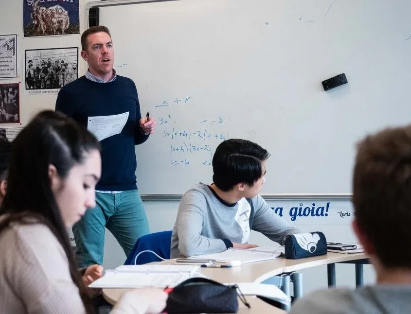 A Higher Ground Learning instructor teaching an SAT math lesson at the whiteboard