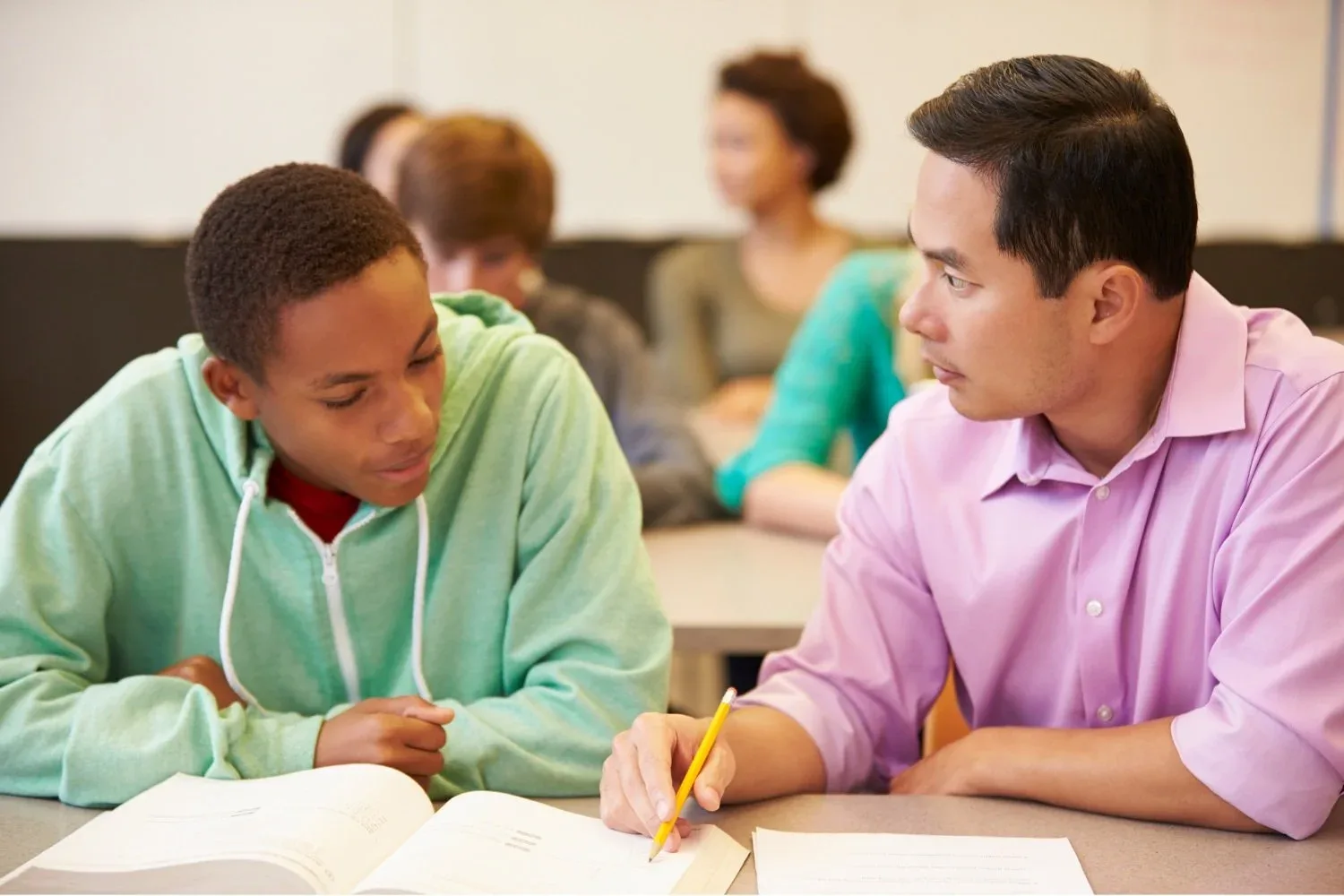 An instructor working one-on-one with a student on test strategy